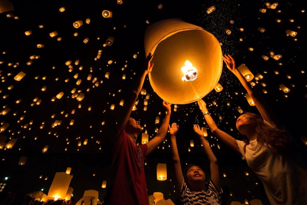 People releasing sky lanterns.